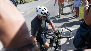 US President Joe Biden falls off while riding his bicycle